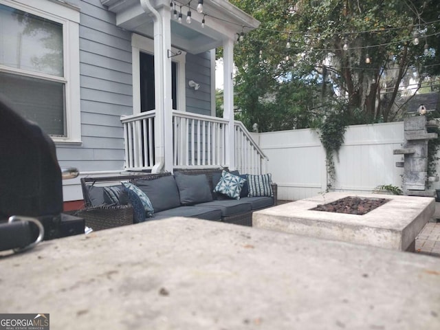 view of patio / terrace featuring an outdoor living space with a fire pit