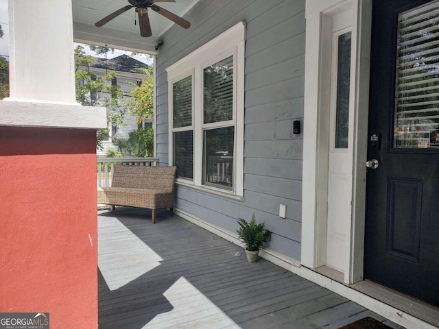 wooden terrace featuring ceiling fan and covered porch