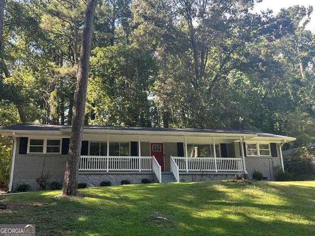 ranch-style house featuring a porch and a front lawn