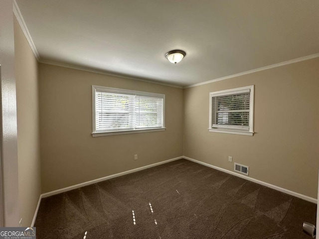 carpeted empty room featuring crown molding