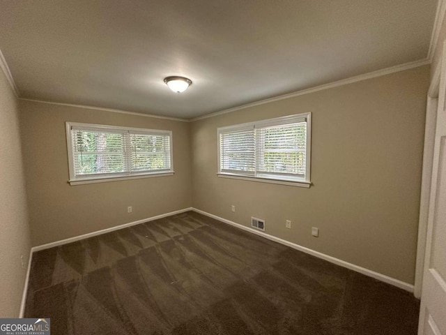 carpeted spare room featuring crown molding