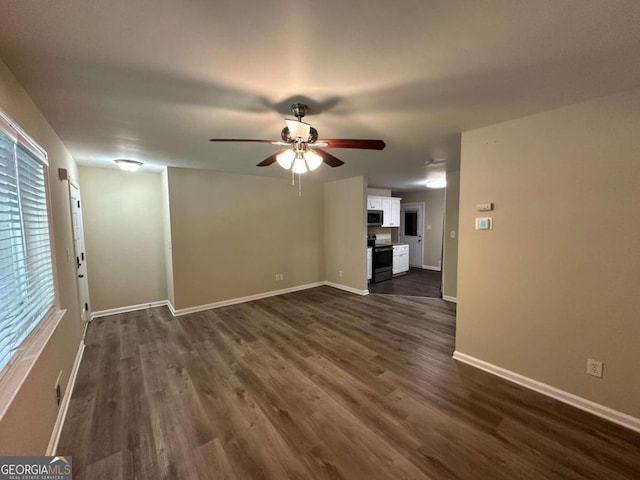 empty room featuring ceiling fan and dark hardwood / wood-style floors