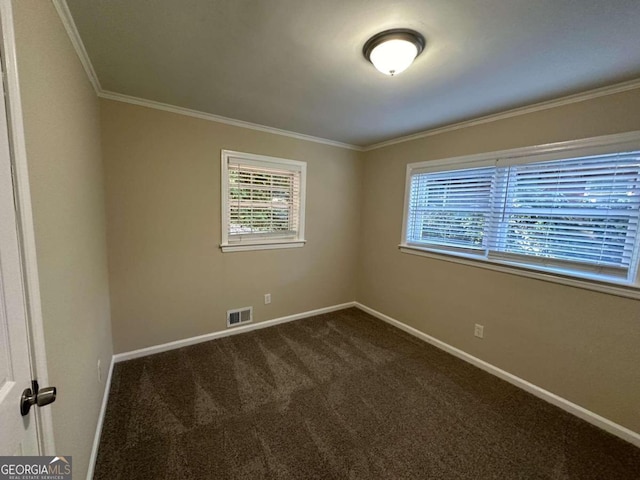 carpeted spare room with crown molding