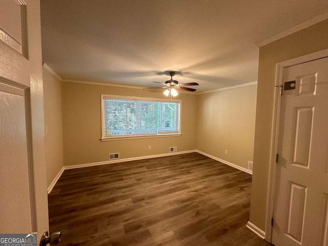 empty room featuring ceiling fan, dark hardwood / wood-style flooring, and crown molding