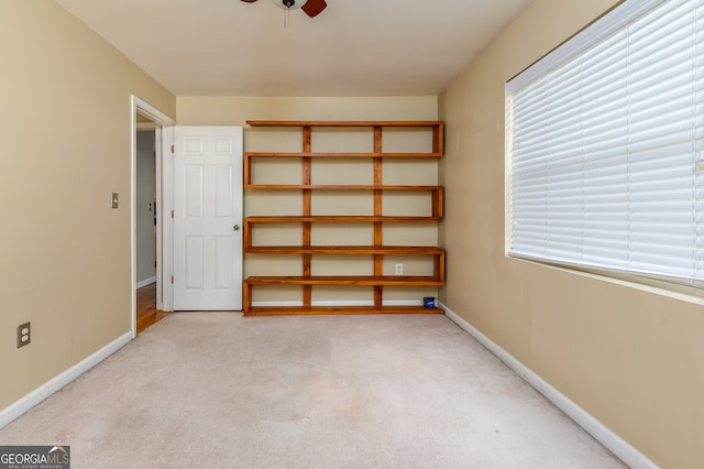 interior space with ceiling fan