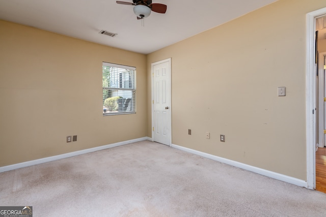 unfurnished room featuring light colored carpet and ceiling fan