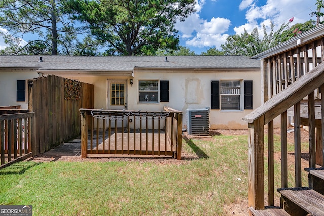 exterior space featuring cooling unit and a lawn