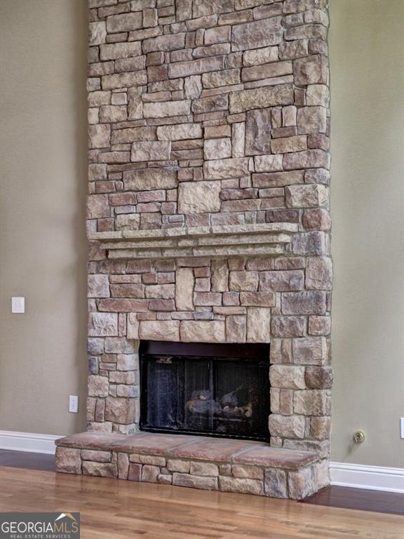 interior details featuring hardwood / wood-style flooring and a fireplace