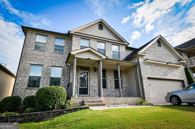 craftsman-style house featuring a garage, a front lawn, and covered porch