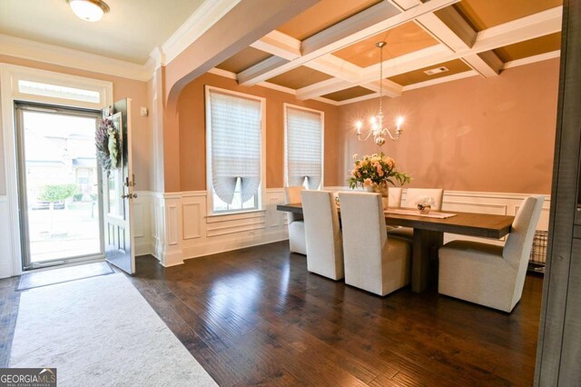 dining space featuring dark wood-type flooring, coffered ceiling, ornamental molding, and beamed ceiling