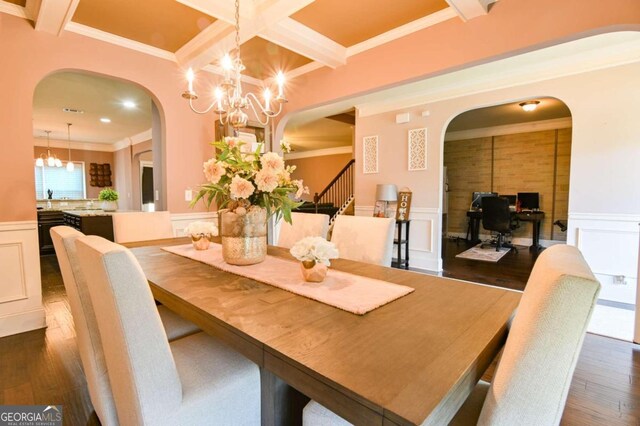 dining room featuring crown molding, dark hardwood / wood-style floors, beamed ceiling, and an inviting chandelier