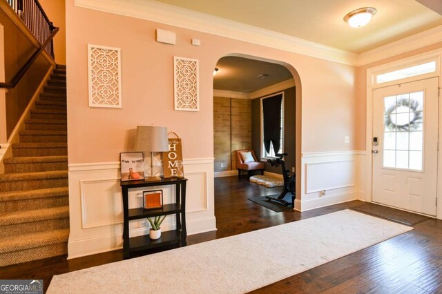 entryway with crown molding and dark hardwood / wood-style floors