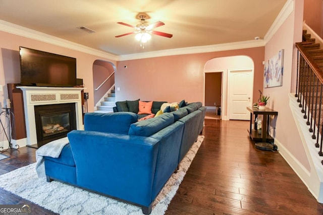 living room with crown molding, ceiling fan, and dark hardwood / wood-style flooring