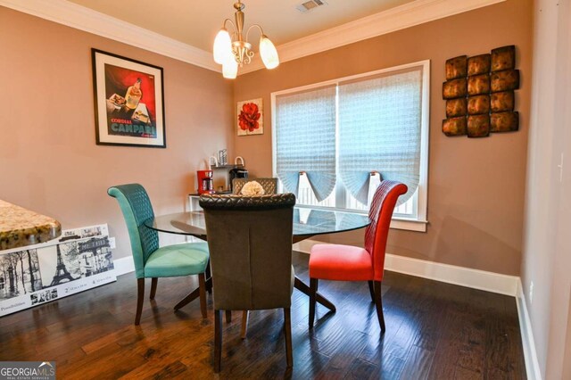 dining room with dark hardwood / wood-style floors, a chandelier, and crown molding