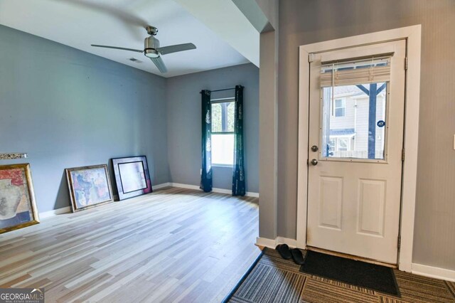 doorway to outside featuring ceiling fan, hardwood / wood-style flooring, and plenty of natural light