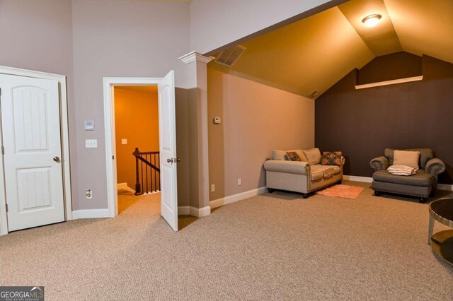 living area with lofted ceiling and carpet flooring