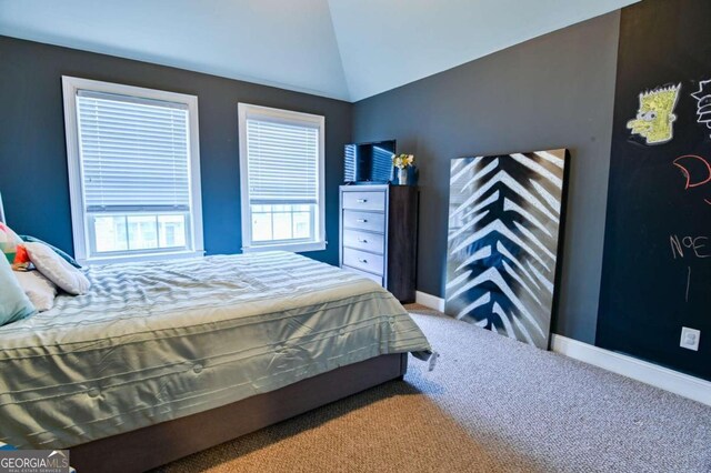 bedroom featuring vaulted ceiling and carpet