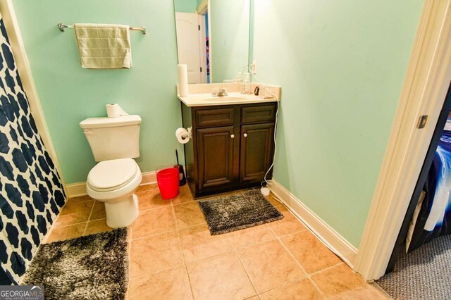 bathroom with vanity, toilet, and tile patterned flooring