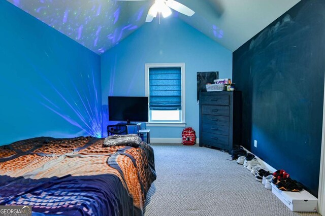 bedroom with ceiling fan, vaulted ceiling, and carpet floors