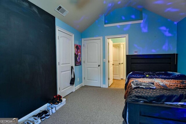 carpeted bedroom with lofted ceiling