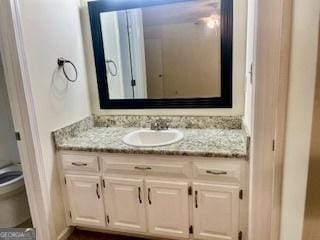 bathroom featuring toilet and vanity