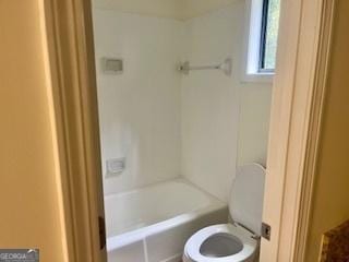 bathroom featuring toilet and a bathing tub