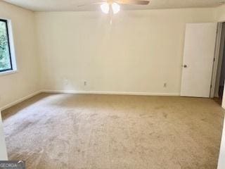 unfurnished room with ceiling fan and carpet flooring