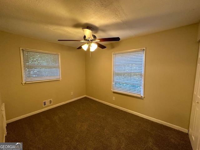 carpeted empty room featuring a textured ceiling and ceiling fan