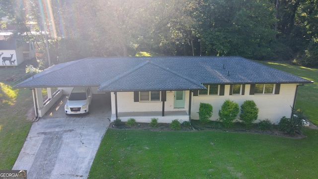 ranch-style home with covered porch, a carport, and a front lawn