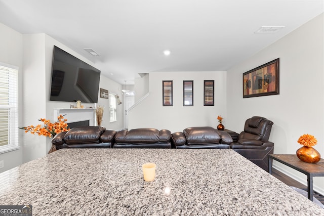 living area with a wealth of natural light, visible vents, and a fireplace