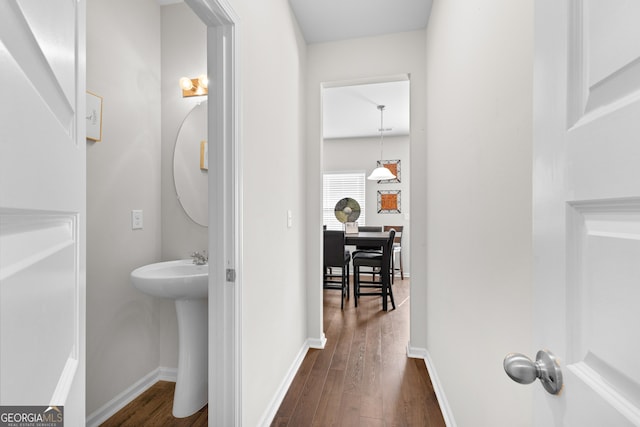 bathroom with baseboards and wood finished floors