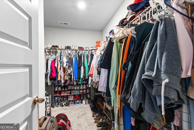 walk in closet featuring visible vents and carpet floors