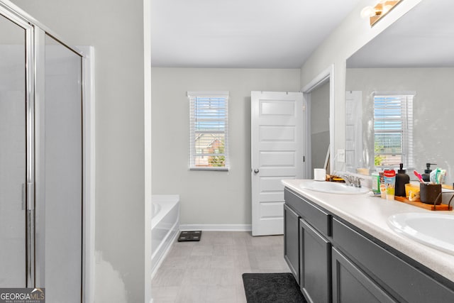 bathroom featuring vanity and shower with separate bathtub