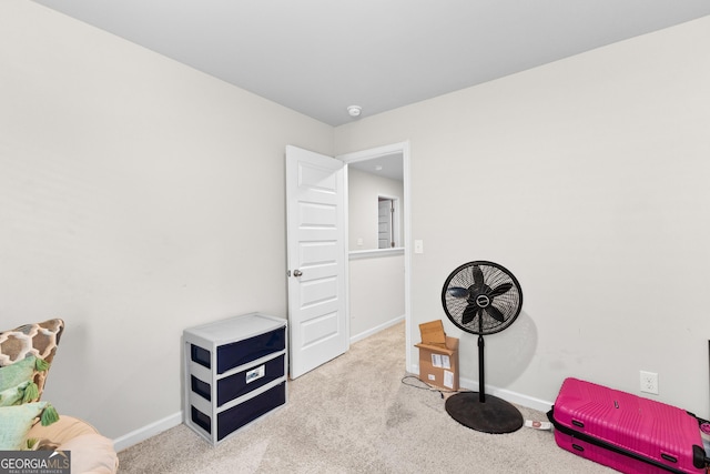 interior space with baseboards and carpet