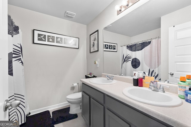 bathroom with vanity, toilet, and a shower with curtain