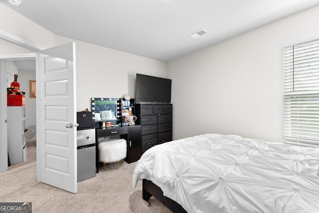 bedroom featuring light carpet