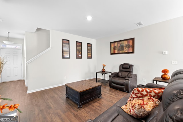 living area featuring baseboards, visible vents, and dark wood-style floors