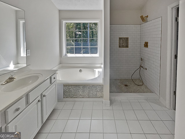 bathroom with tile patterned flooring, separate shower and tub, and vanity