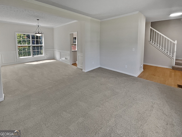 unfurnished living room featuring light carpet, crown molding, a chandelier, and a textured ceiling