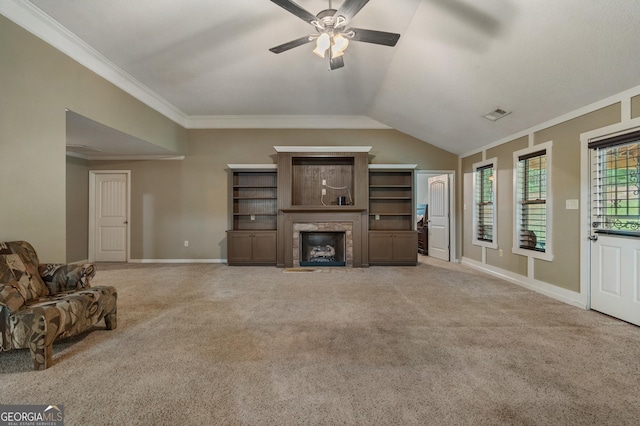 unfurnished living room with ceiling fan, ornamental molding, vaulted ceiling, and light carpet