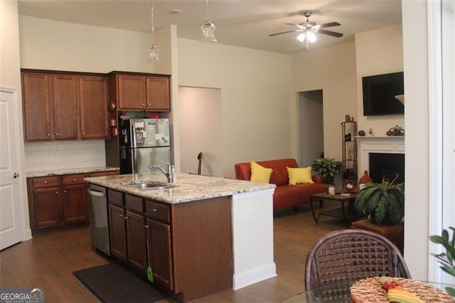 kitchen featuring appliances with stainless steel finishes, hanging light fixtures, ceiling fan, and dark hardwood / wood-style floors