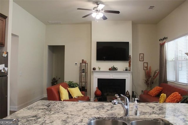 interior space featuring ceiling fan and sink