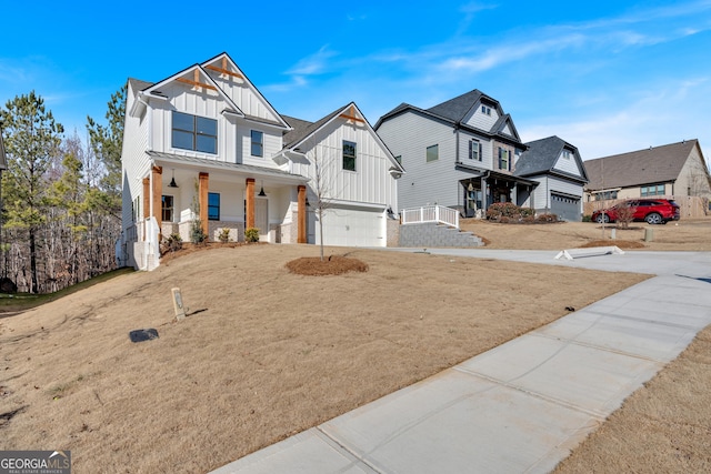 view of front of property featuring a garage, a front yard, and a porch