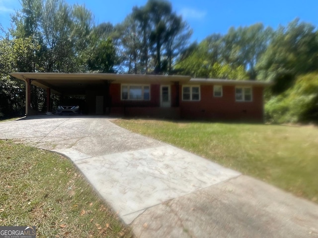 ranch-style house featuring a carport and a front yard