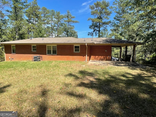 back of house featuring a yard and a carport