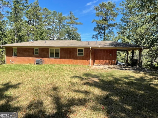 back of house featuring a yard and a carport