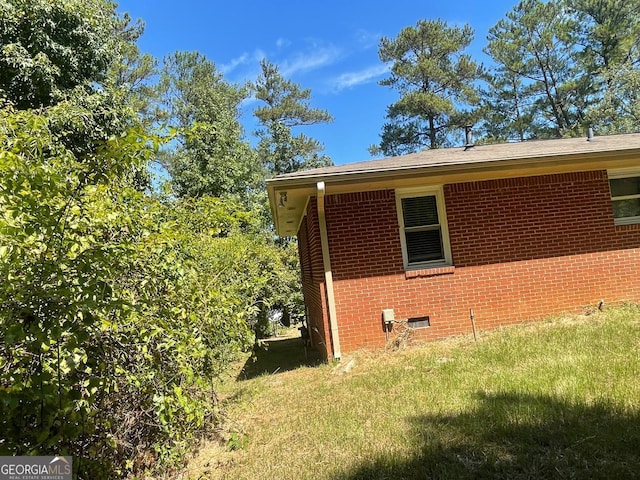 view of side of home featuring a lawn