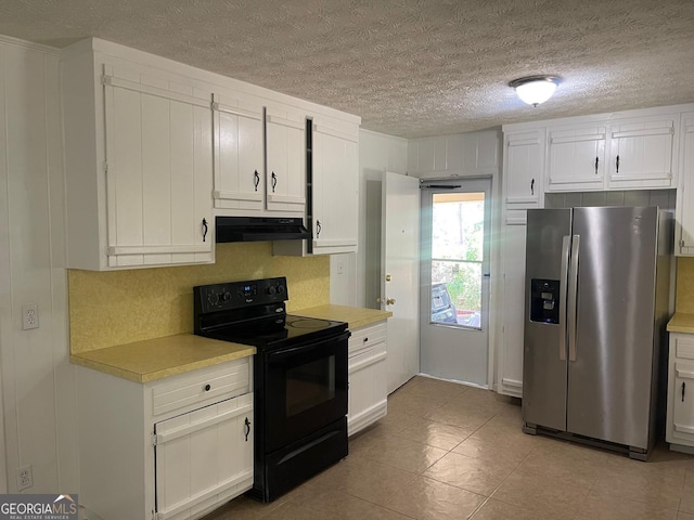 kitchen with a textured ceiling, exhaust hood, stainless steel fridge, black electric range oven, and white cabinets