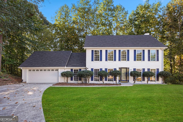 view of front of house featuring a front yard and a garage