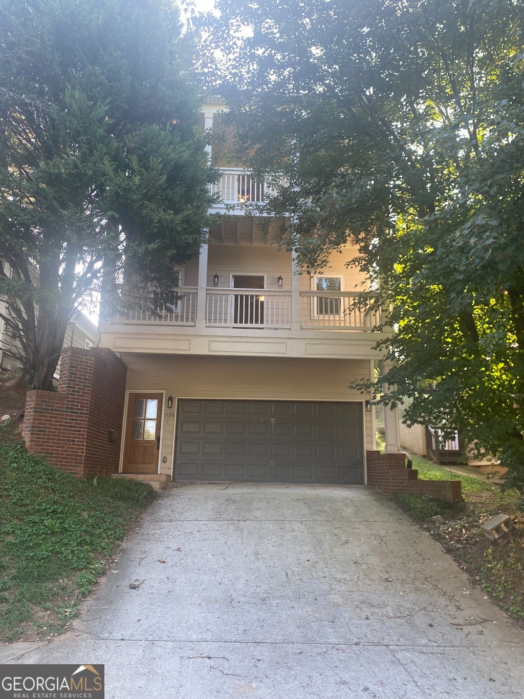 view of front of home with a balcony and a garage